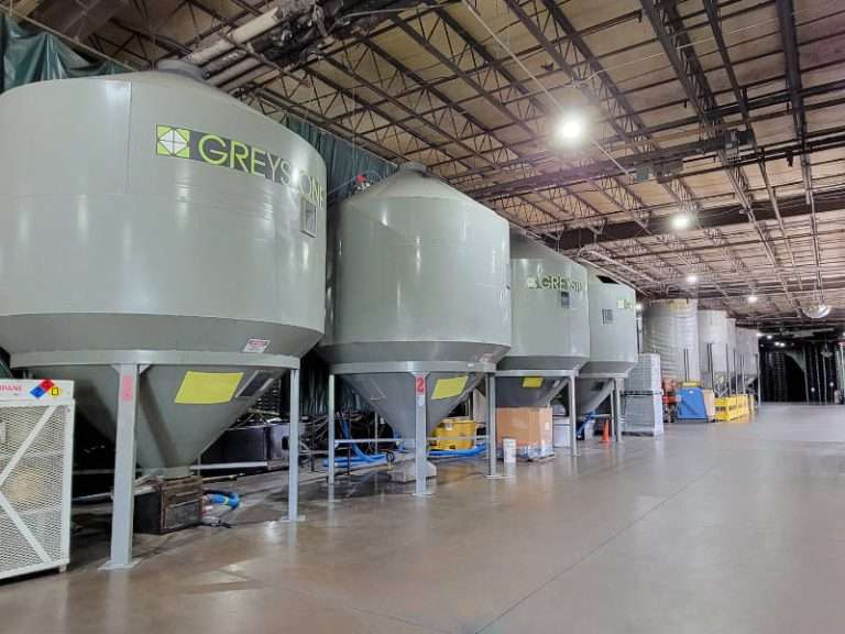 Silos for storing material for plastic pallets.